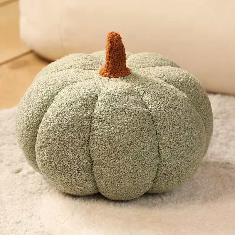 Green textured pumpkin-shaped pillow on a soft surface