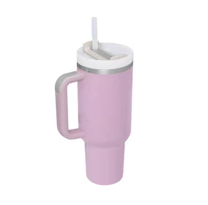 Pink tumbler with a handle and straw lid on a white background