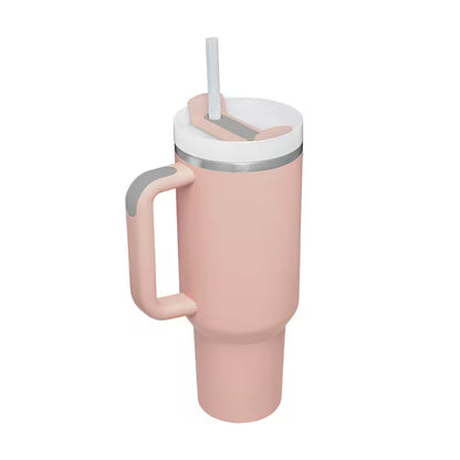 Pink travel mug with a handle and straw lid on a white background