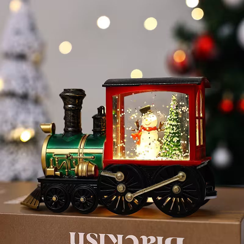Decorative train with a snowman and Christmas tree inside, on a blurred festive background.