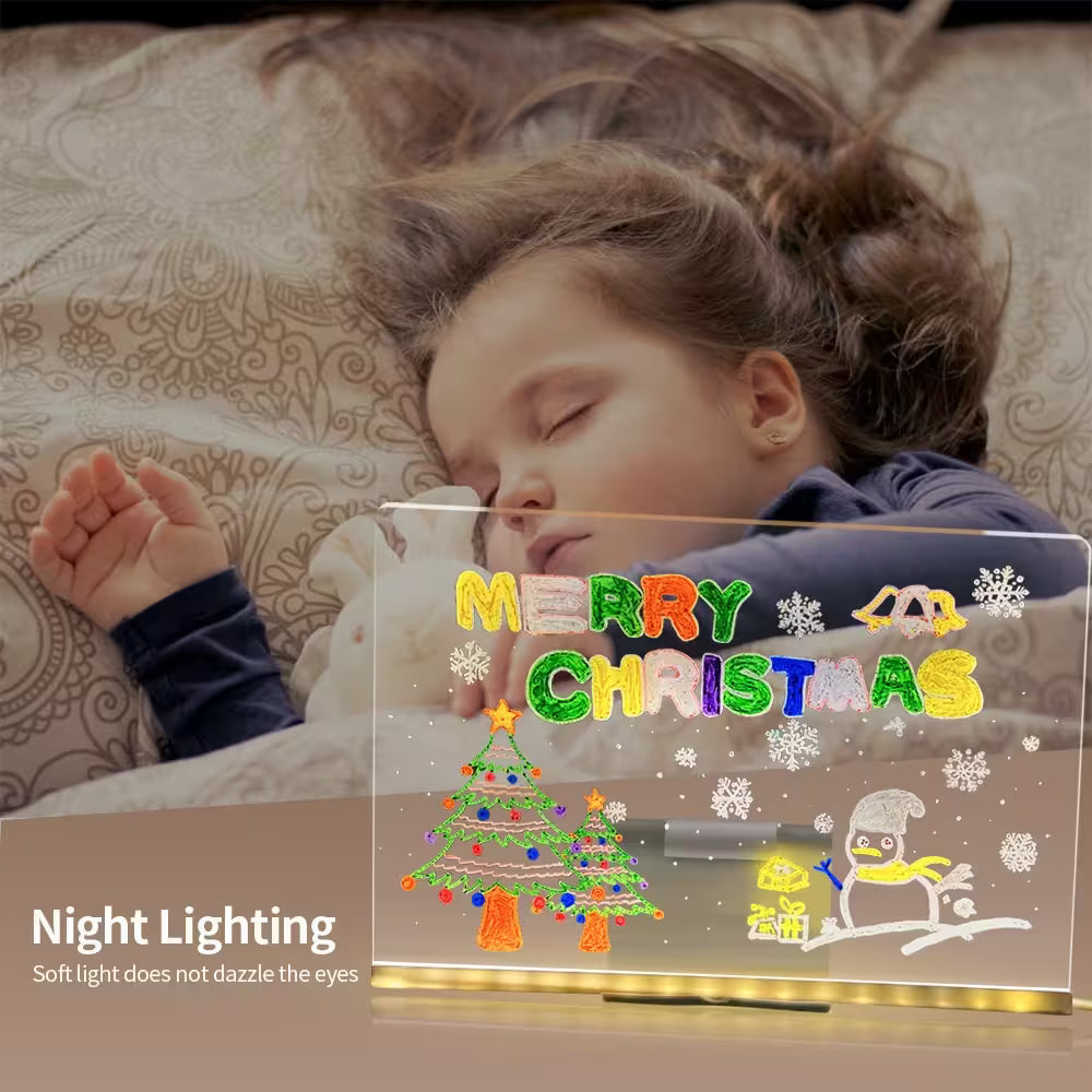 Child lying on a bed with a 'Merry Christmas' night light in front of them.