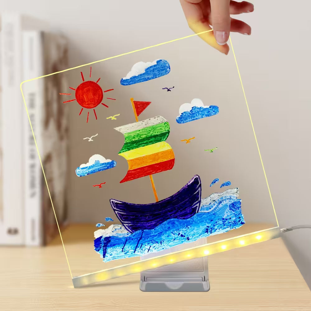 Colorful sailboat drawing on a transparent board with LED lighting, held by a hand.