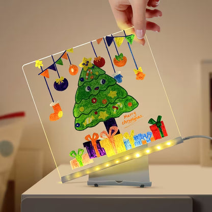 Decorative LED sign with a Christmas tree and presents design, held by a hand.