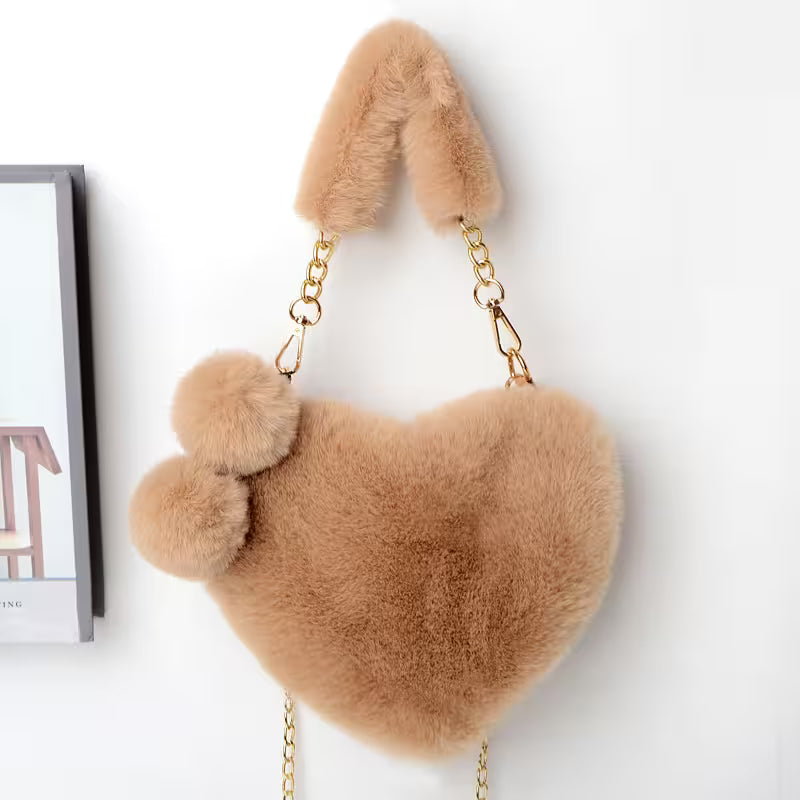 Brown fluffy heart-shaped handbag with chain strap on a white background