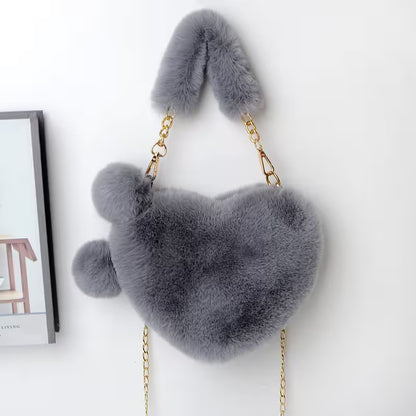 Gray fluffy bag with gold chain on a white background