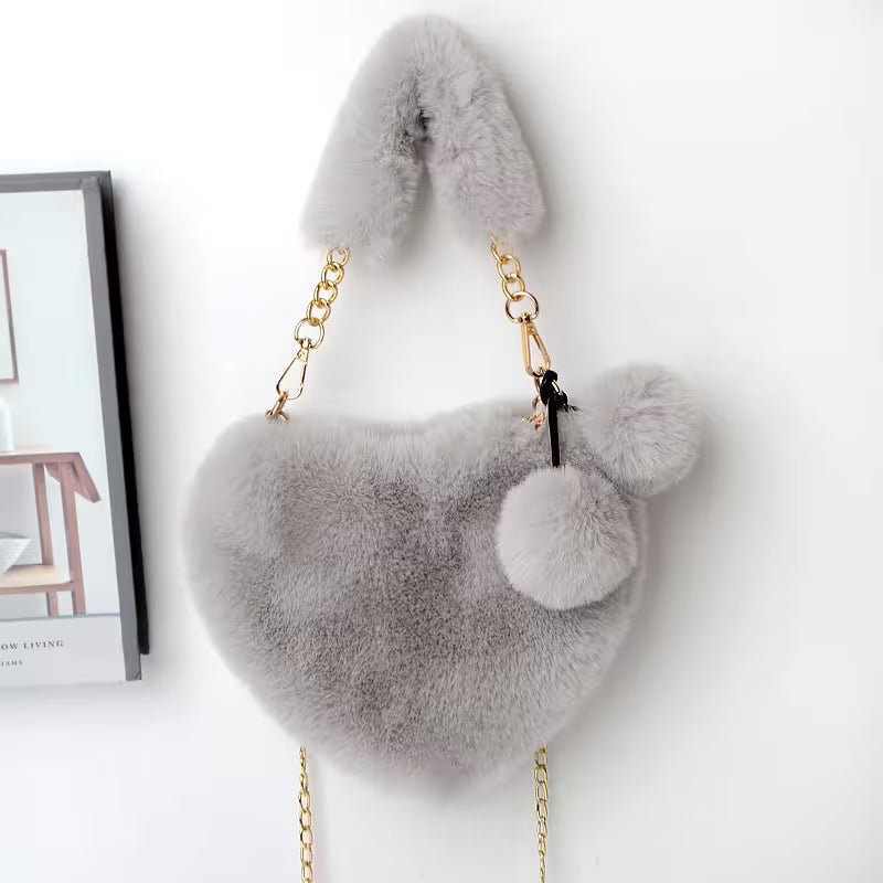 Gray fluffy handbag with gold chain on a white background