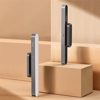 Two modern door handles on a wooden surface with a neutral background