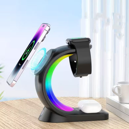 Multi-device charging stand with smartphone, smartwatch, and wireless charger on a desk.