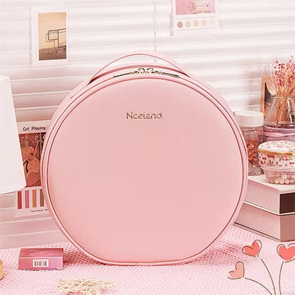 Pink round bag with 'Nacenda' branding on a decorative surface.