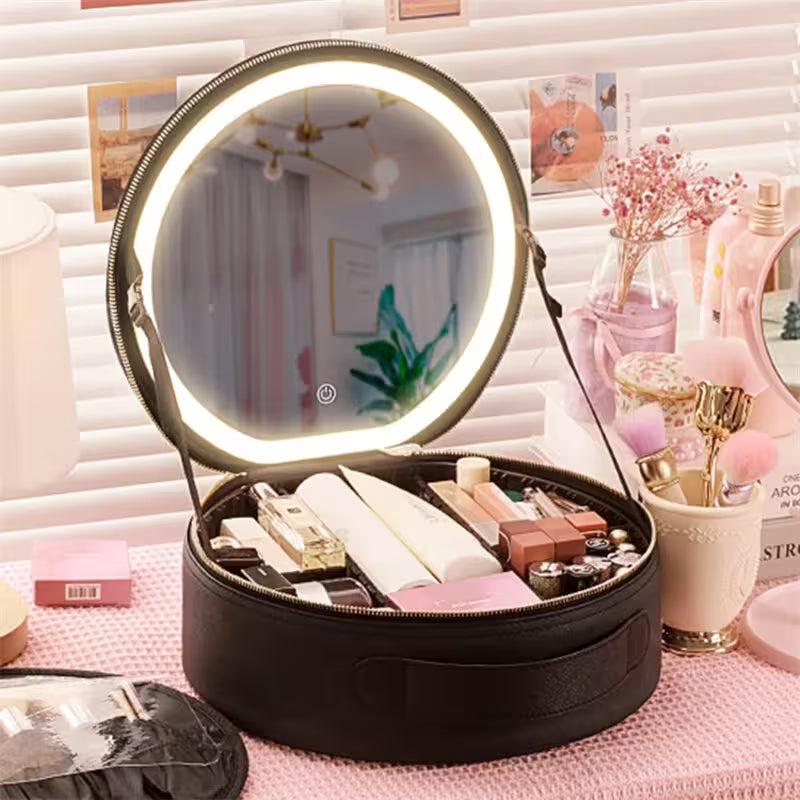 Makeup case with a round mirror featuring LED lighting on a pink surface.