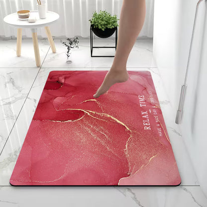Pink textured mat with gold accents and text on a marble floor.