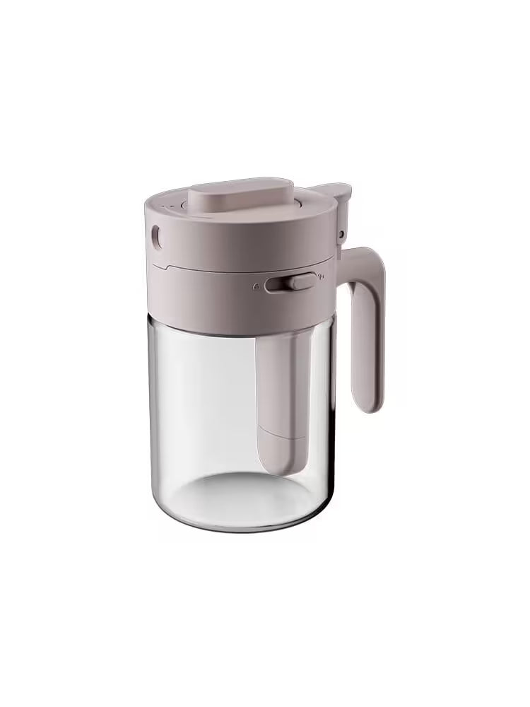 Clear glass pitcher with beige lid and handle on a white background