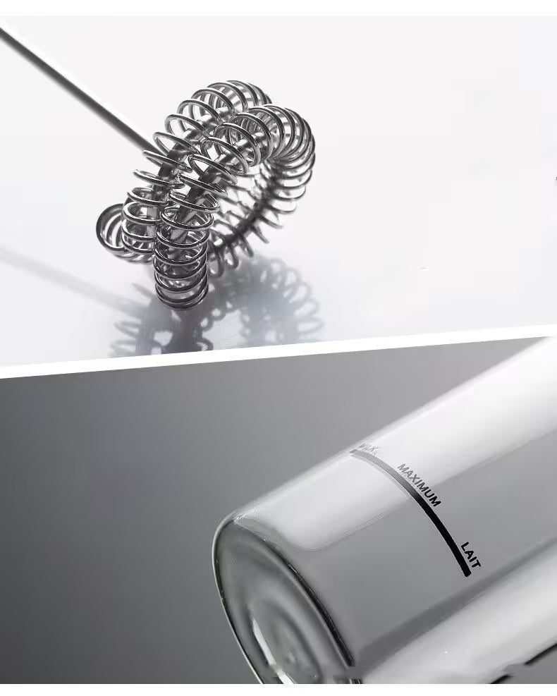 Metallic whisk on a reflective surface with a blurred kitchen appliance in the foreground