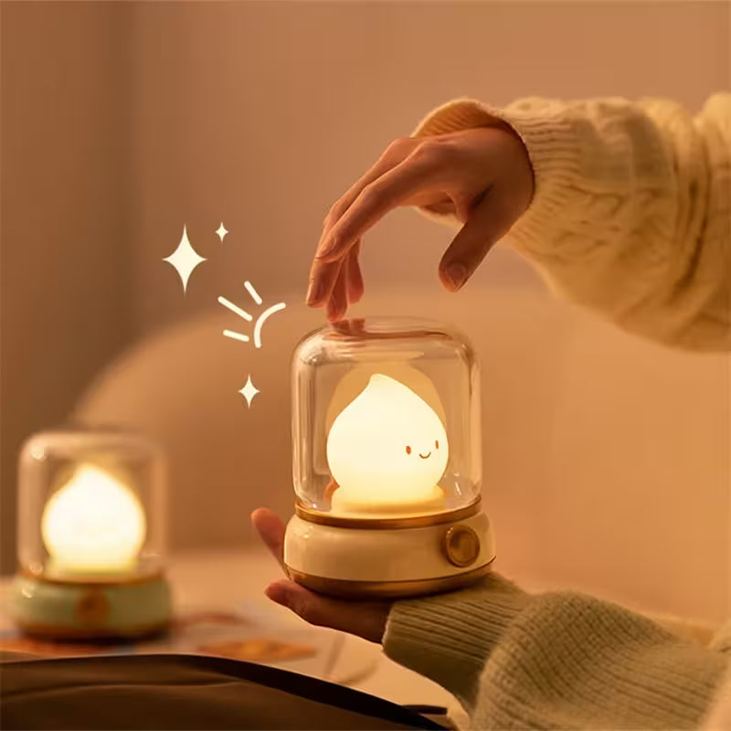 Hand holding a small, cute night light with a warm glow, surrounded by soft lighting and a cozy atmosphere.