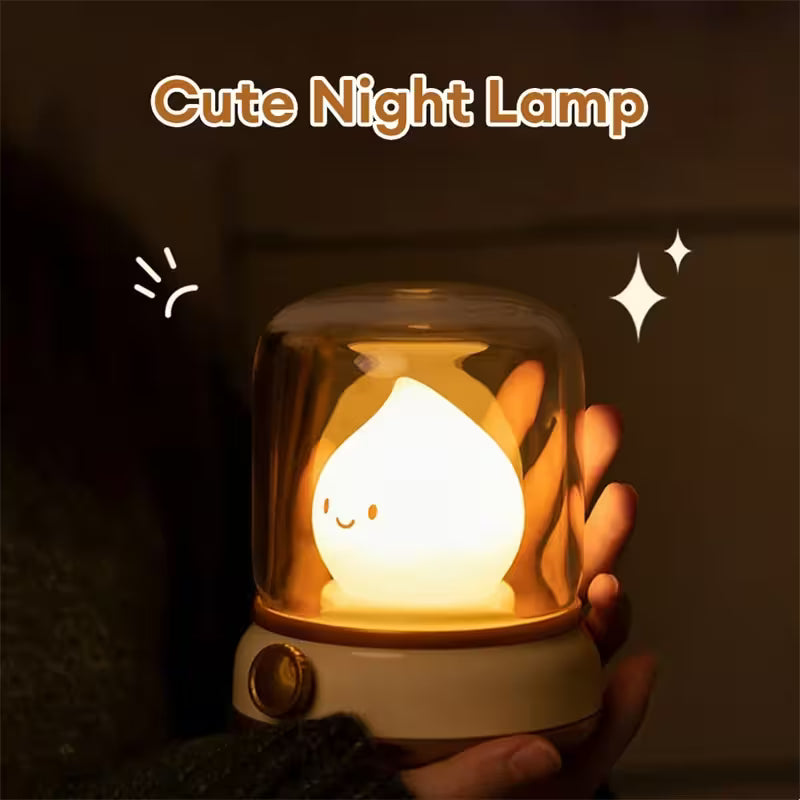 Cute night lamp held in a hand with a dark background