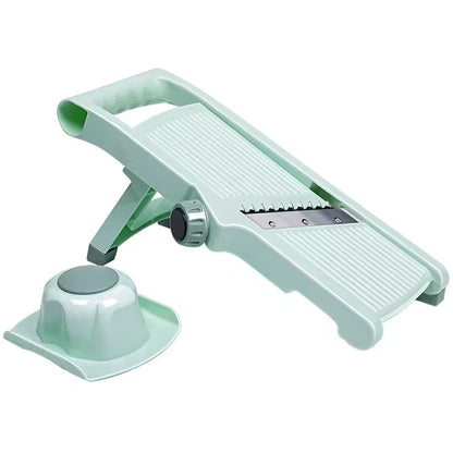 Light green vegetable peeler on a white background