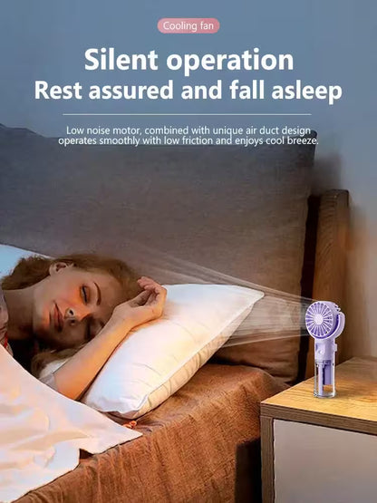 Person sleeping in bed with a cooling fan on a nightstand, emphasizing silent operation.