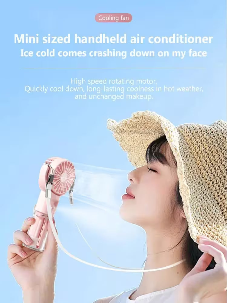 Person wearing a straw hat holding a mini handheld air conditioner against a blue sky.
