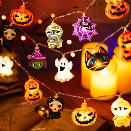 Halloween-themed string lights with various characters on a wooden surface.