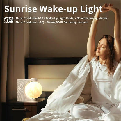 Woman waking up in a bedroom with a sunrise wake-up light on a nightstand.