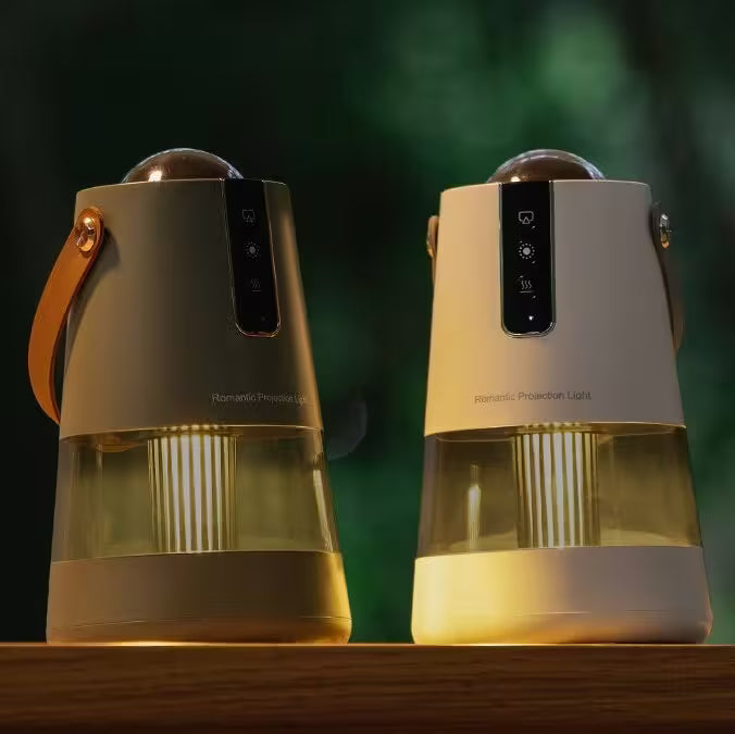 Two portable projectors on a wooden surface with a blurred green background