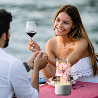 Couple enjoying a romantic dinner by the water with a candle and wine glass.