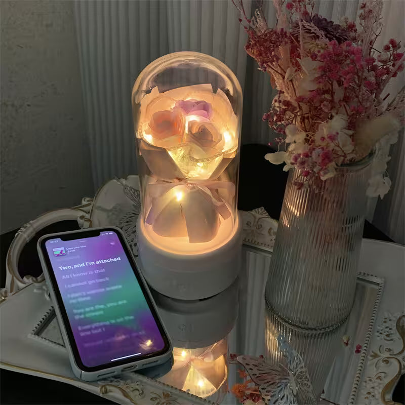 Decorative lighted owl in a glass dome on a table with a phone displaying text.