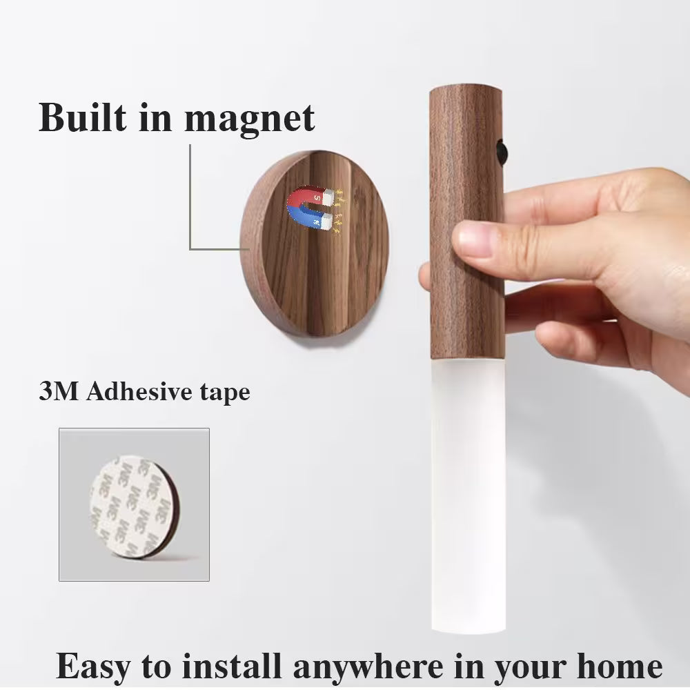 Wooden magnetic strip with adhesive tape, held by a hand, on a white background.
