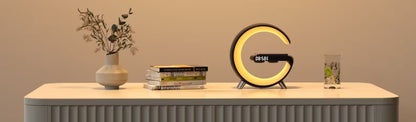 Decorative table with a vase, books, and a circular night light on a beige background