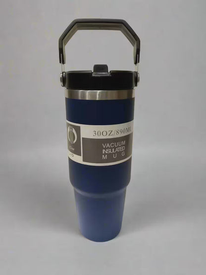 Blue vacuum insulated mug with handle on a gray background
