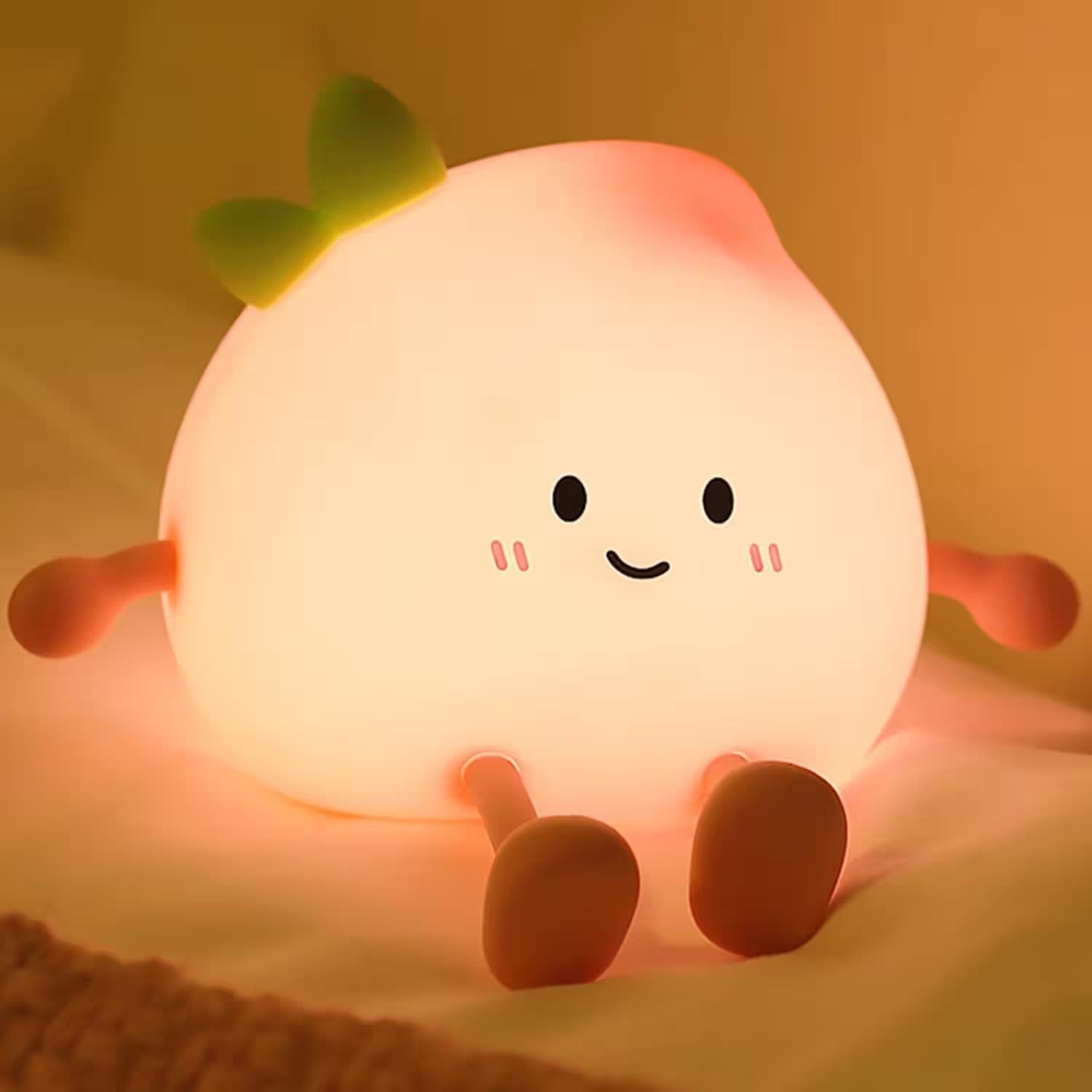 Cute character-shaped night light with a smiling face on a soft surface.