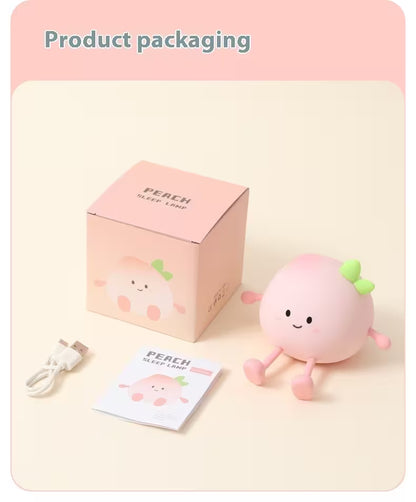 Pink plush toy with packaging and USB cable on a beige background