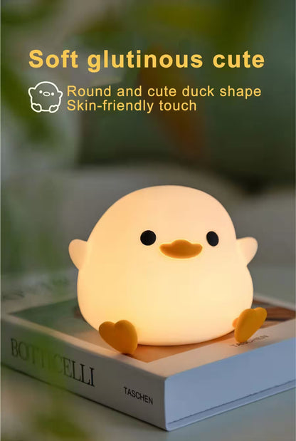 Cute duck-shaped night light on a book with text describing its soft and cute features.