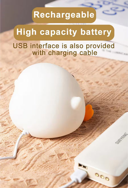 White spherical device with orange accents on a wooden surface, connected to a power bank via USB cable.