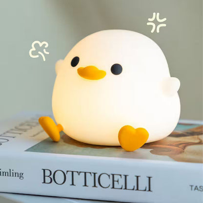 Cute chick-shaped night light on a book with 'Botticelli' visible