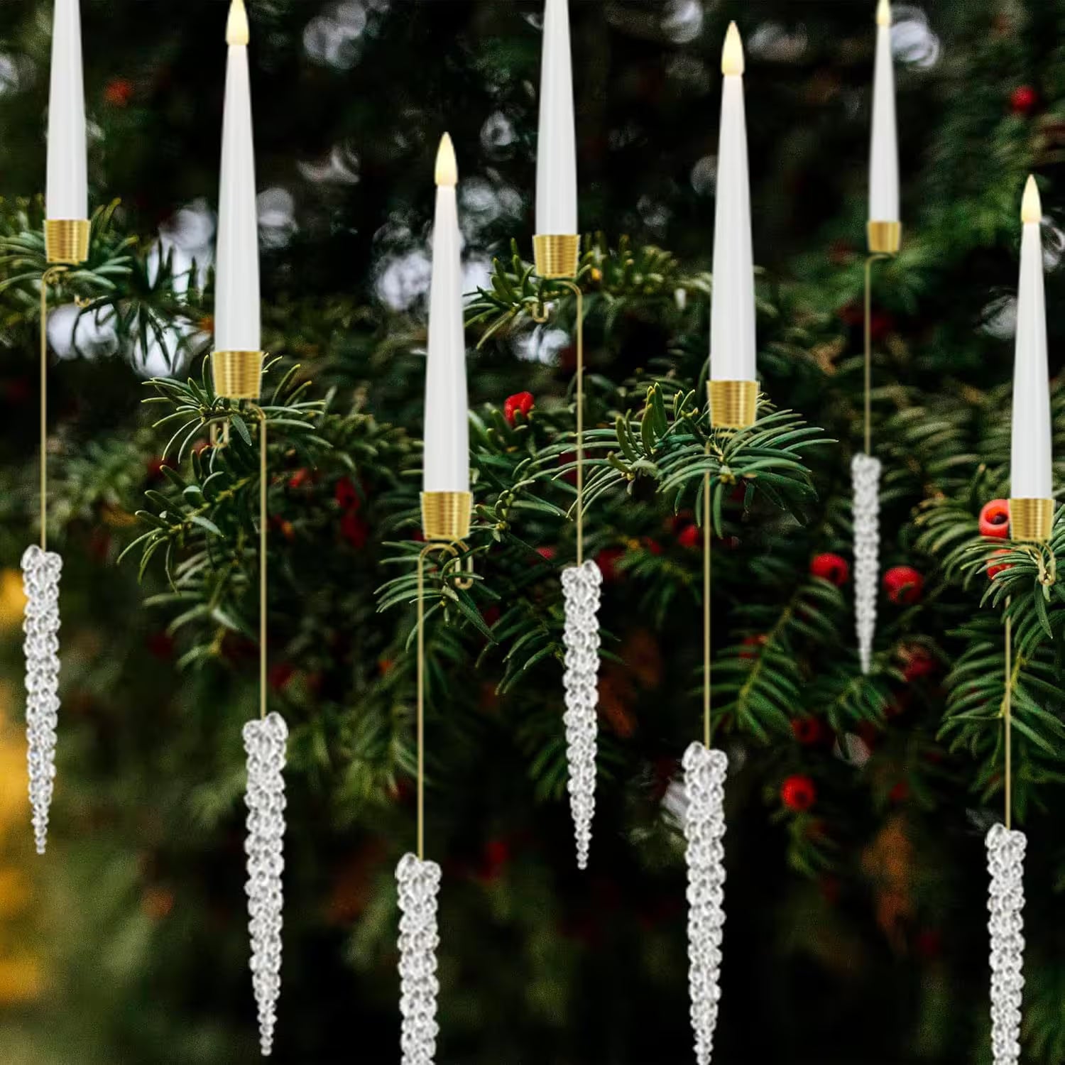 Decorative candles with gold bases and crystal icicle details on a Christmas tree.