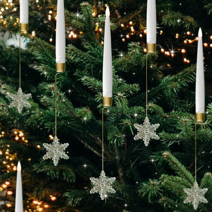 Decorative candles with snowflake ornaments hanging on a Christmas tree.
