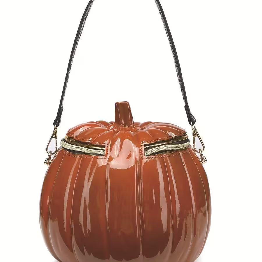Pumpkin-shaped handbag with a black strap on a white background