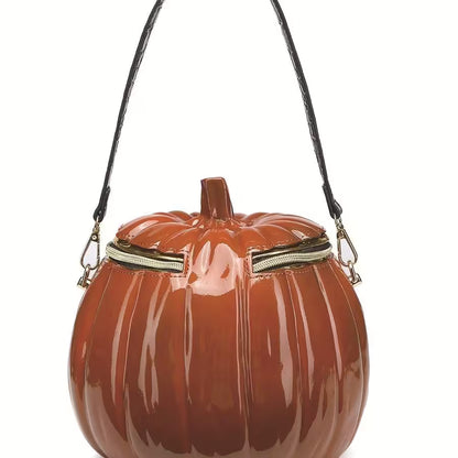 Pumpkin-shaped handbag with a black strap on a white background