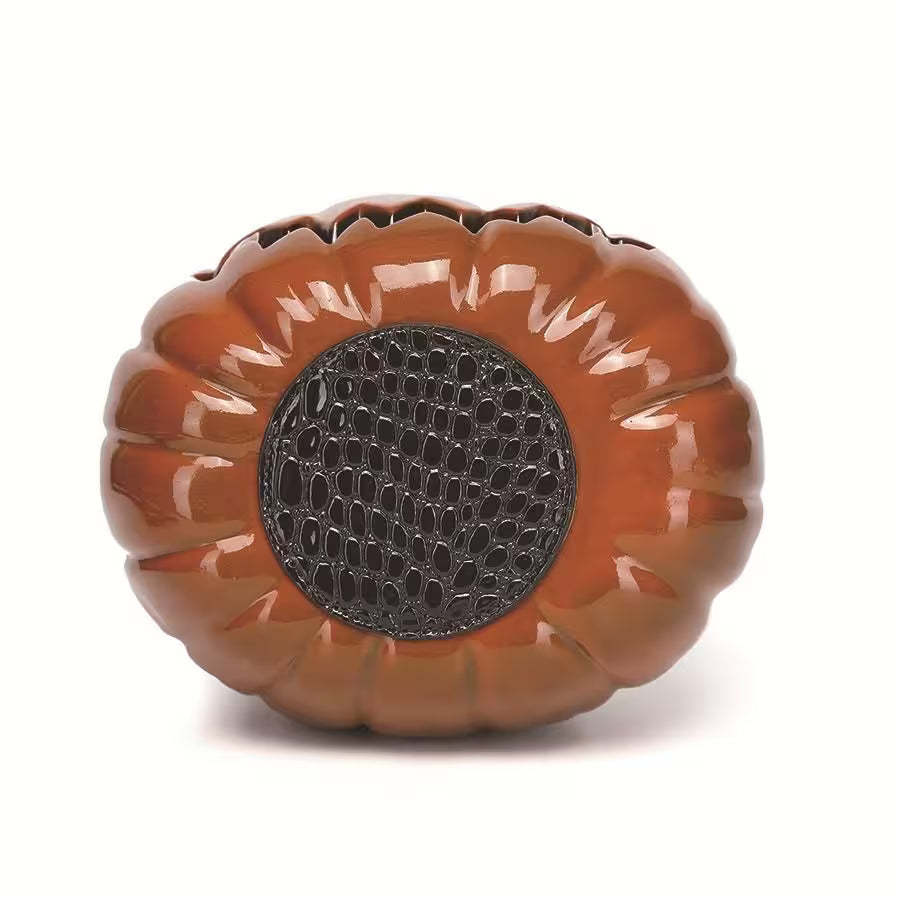 Decorative pumpkin-shaped object with a textured center on a white background