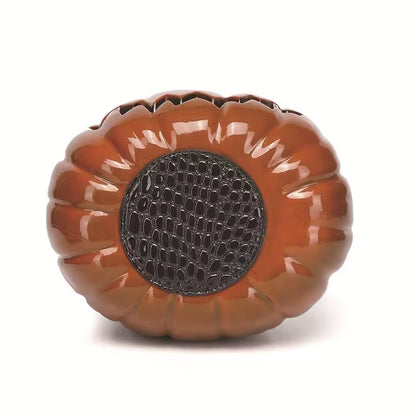 Decorative pumpkin-shaped object with a textured center on a white background