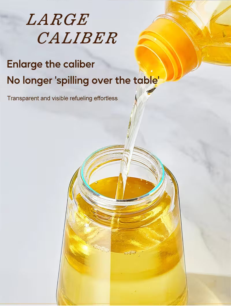 Yellow liquid being poured from a large caliber bottle into a glass jar on a white background.