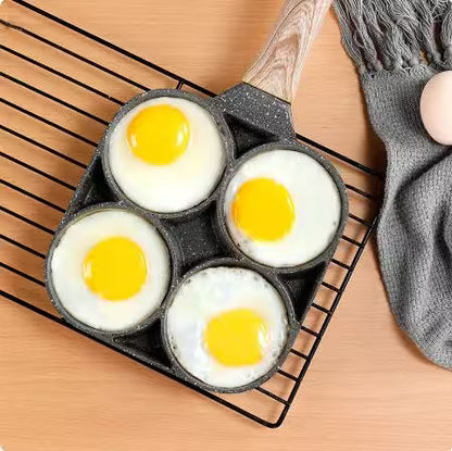 Four eggs in a muffin tin on a cooling rack with a wooden surface and gray towel in the background.
