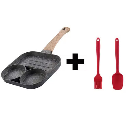 Gray frying pan with wooden handle and two red silicone utensils on a white background