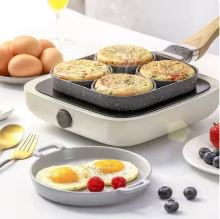 Multifunctional cooking appliance with muffin and egg dishes on a table.