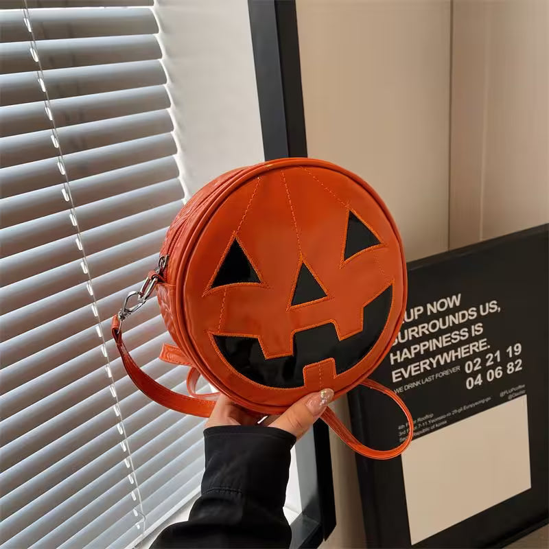 Pumpkin-shaped bag with a face design held in front of a window.