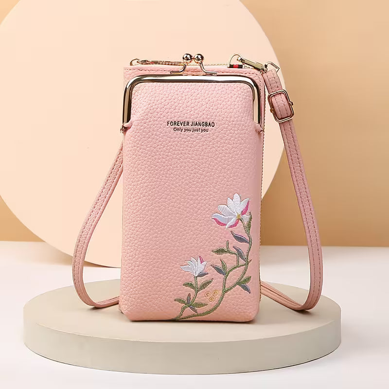 Pink crossbody bag with floral embroidery on a beige background