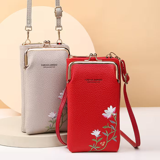 Two handbags, one red and one gray, with floral embroidery on a beige background.