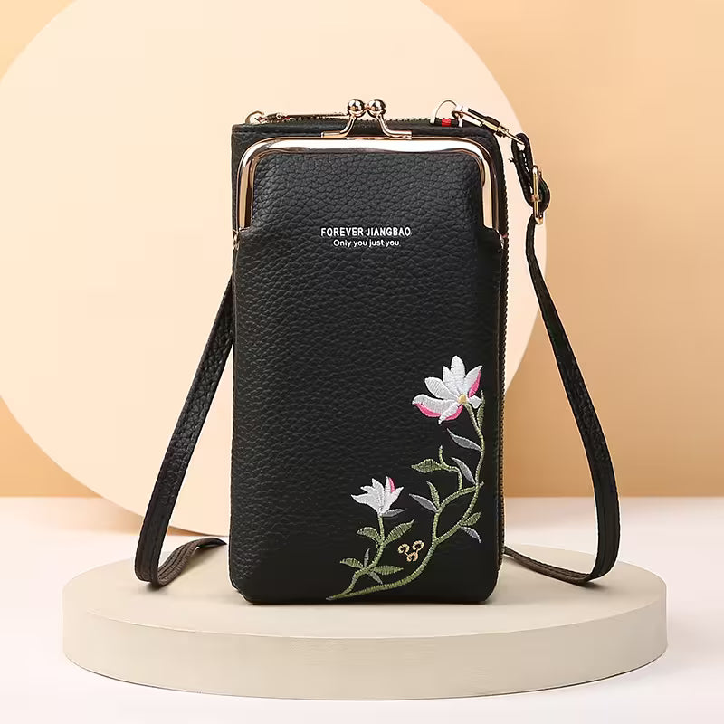 Black phone bag with floral embroidery on a beige background