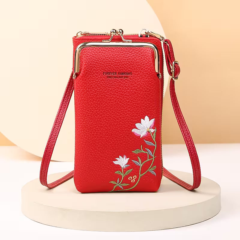 Red phone bag with floral embroidery on a beige background